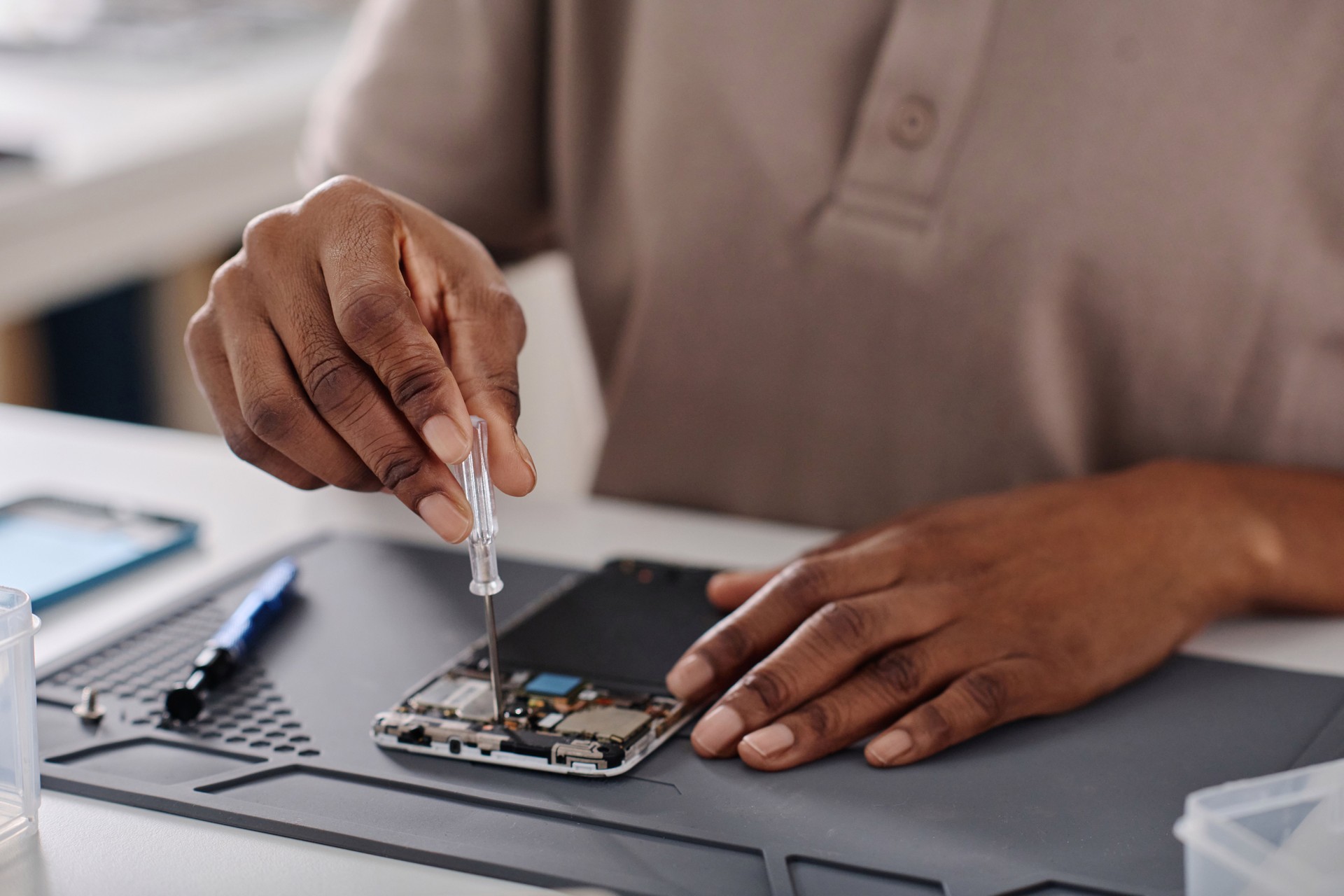 African American Technician Fixing Faulty Mobile Phone
